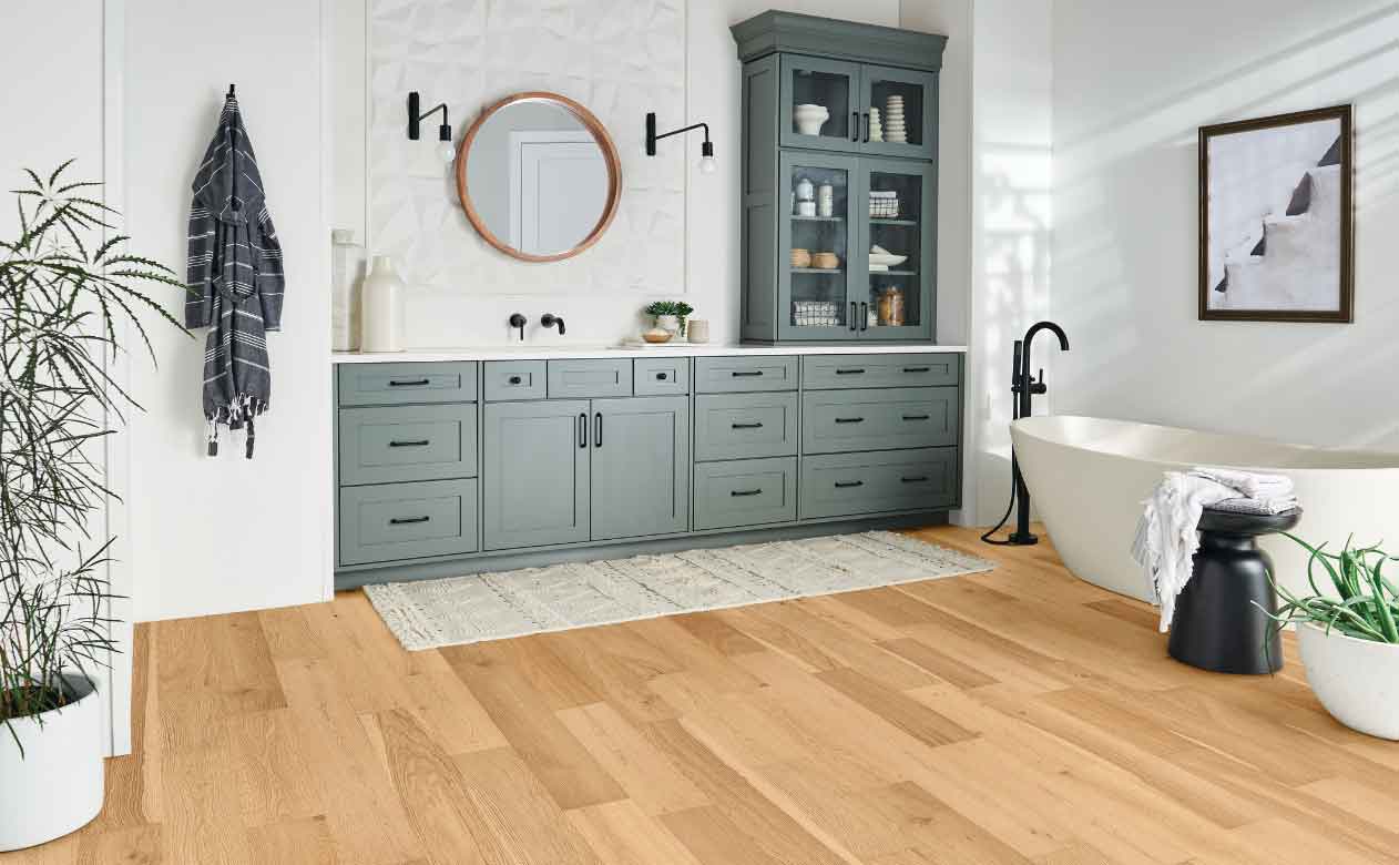 white oak waterproof hardwood in modern bathroom with blue cabinetry