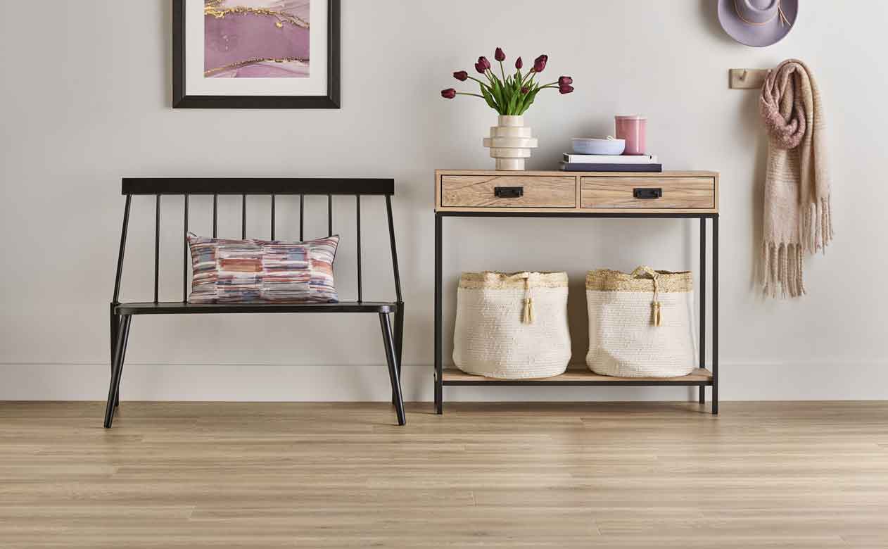 light wood look laminate flooring in modern entryway with entryway bench and table